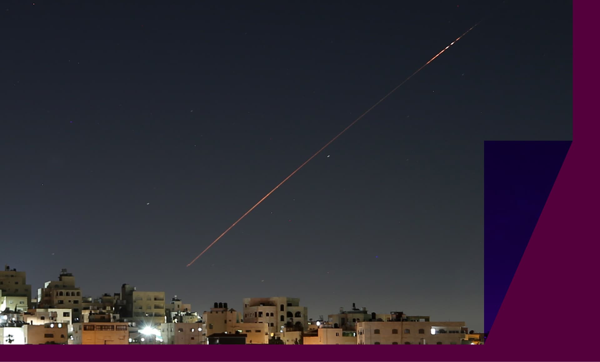 Missiles launched from Iran toward Israel are seen in the sky over the West Bank city of Hebron.