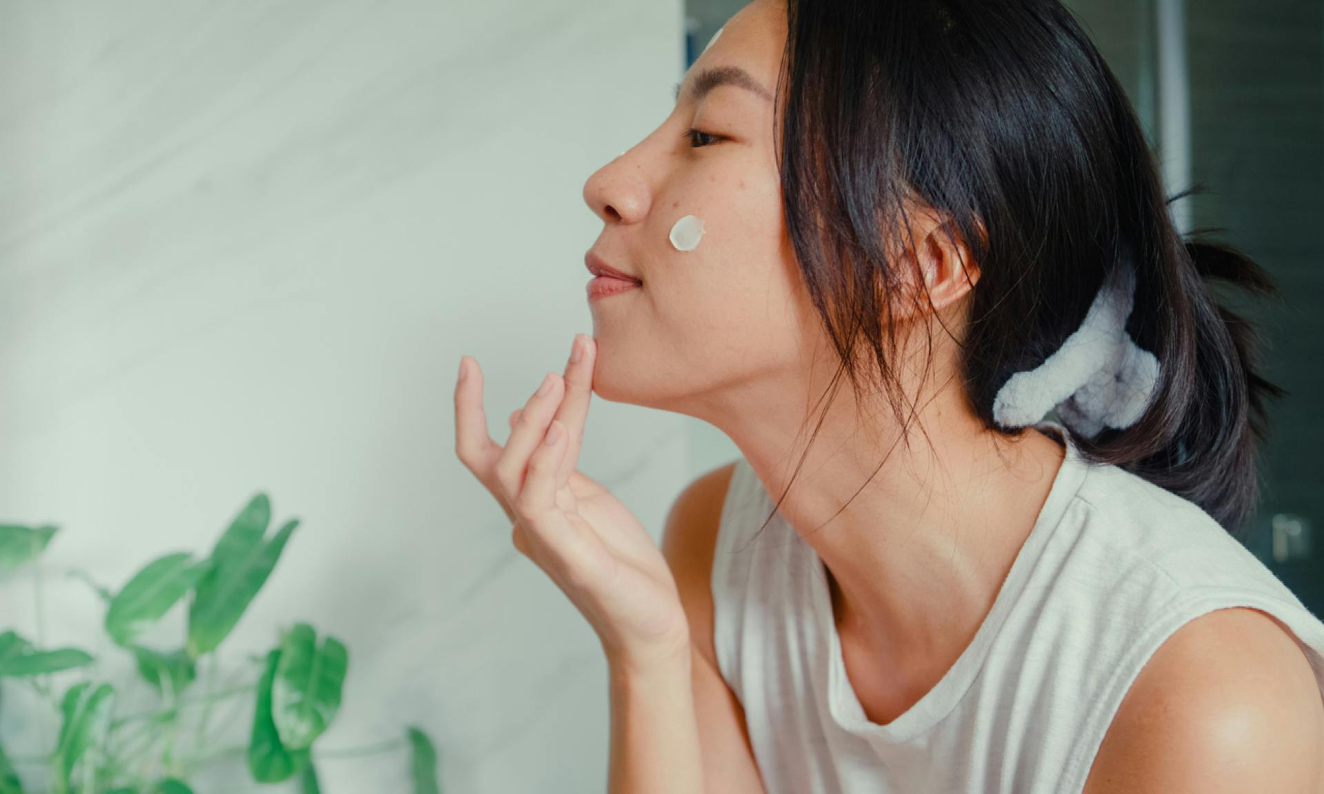 woman treating pimple