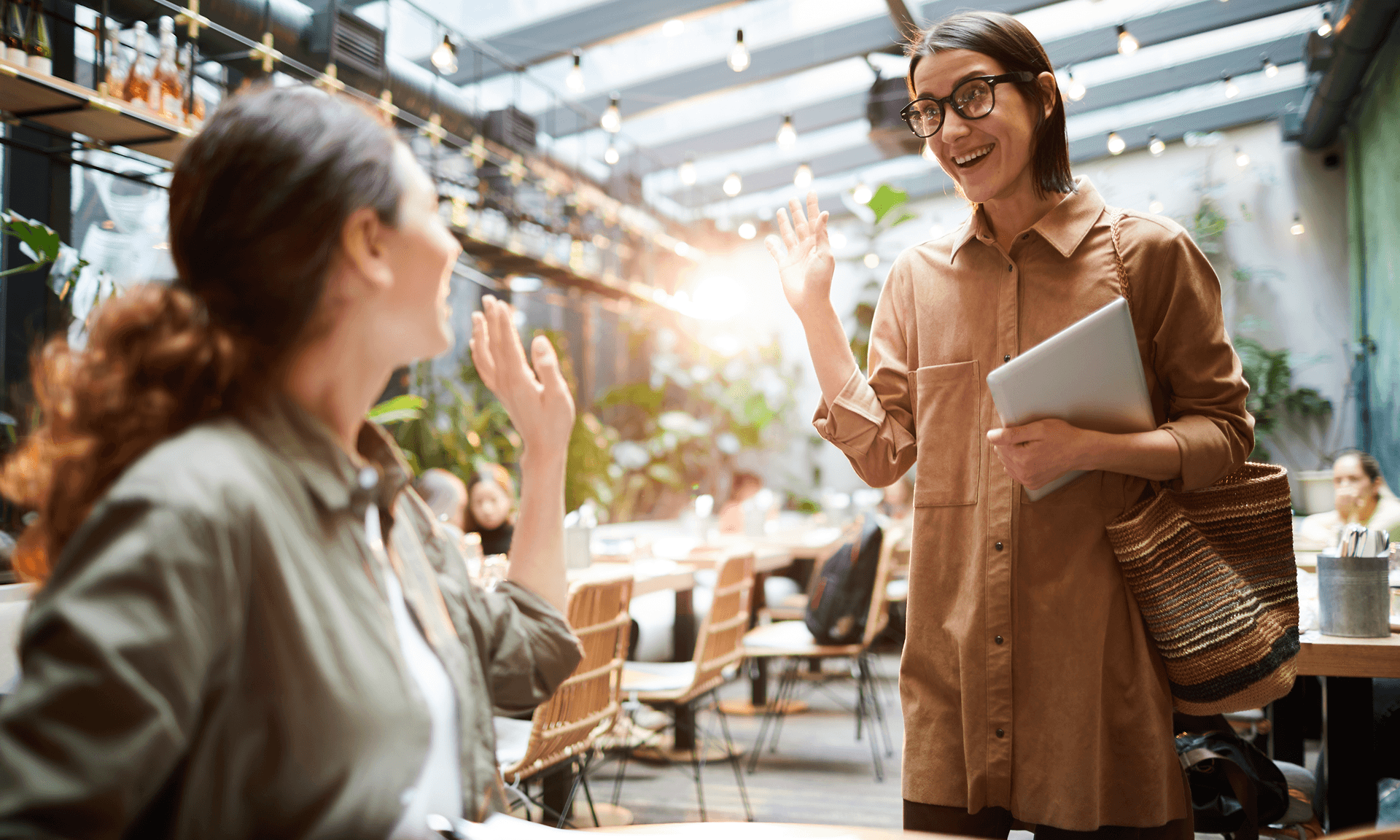 Two women running into each other at a cafe