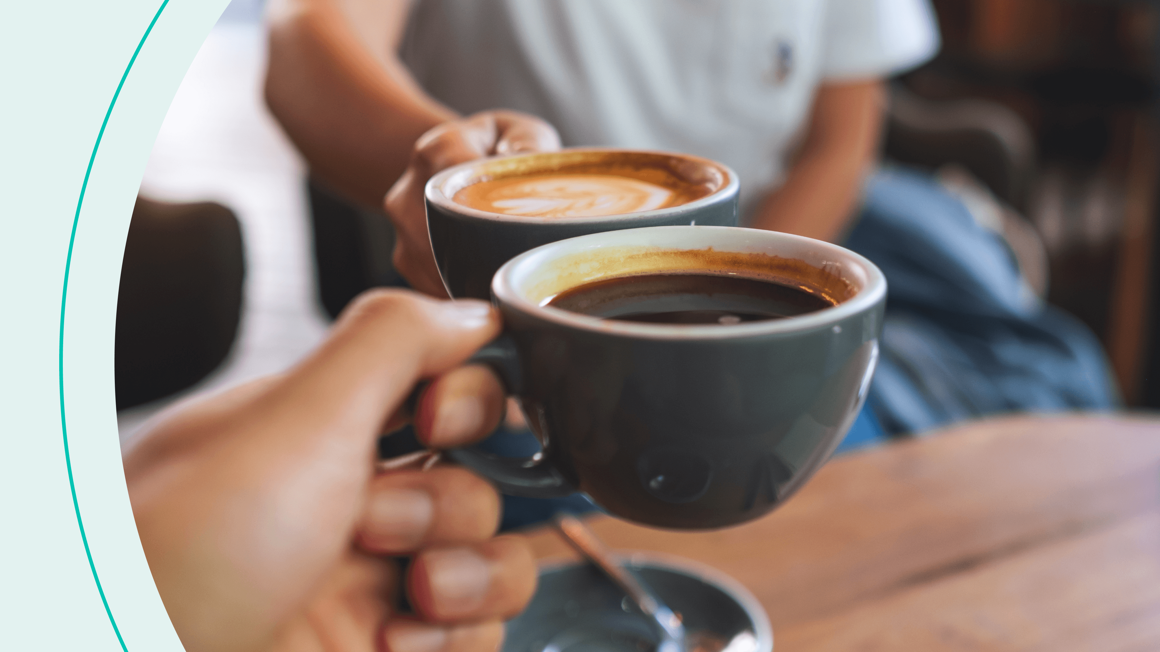 Two people clinking coffee mugs