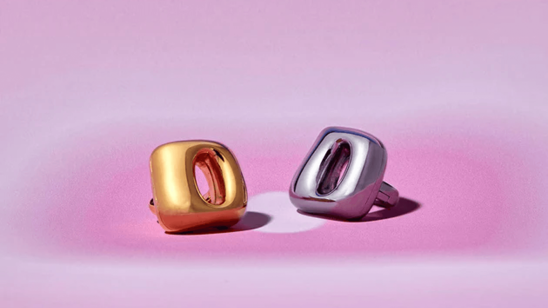 Silver and gold Unbound Flicks on pink gradient background