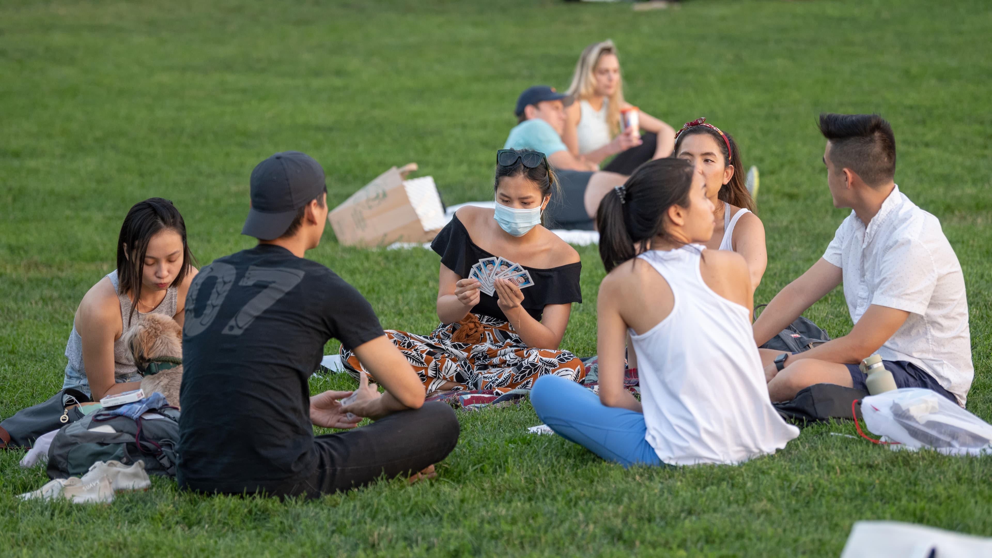 A woman wearing a mask in the park in NYC.