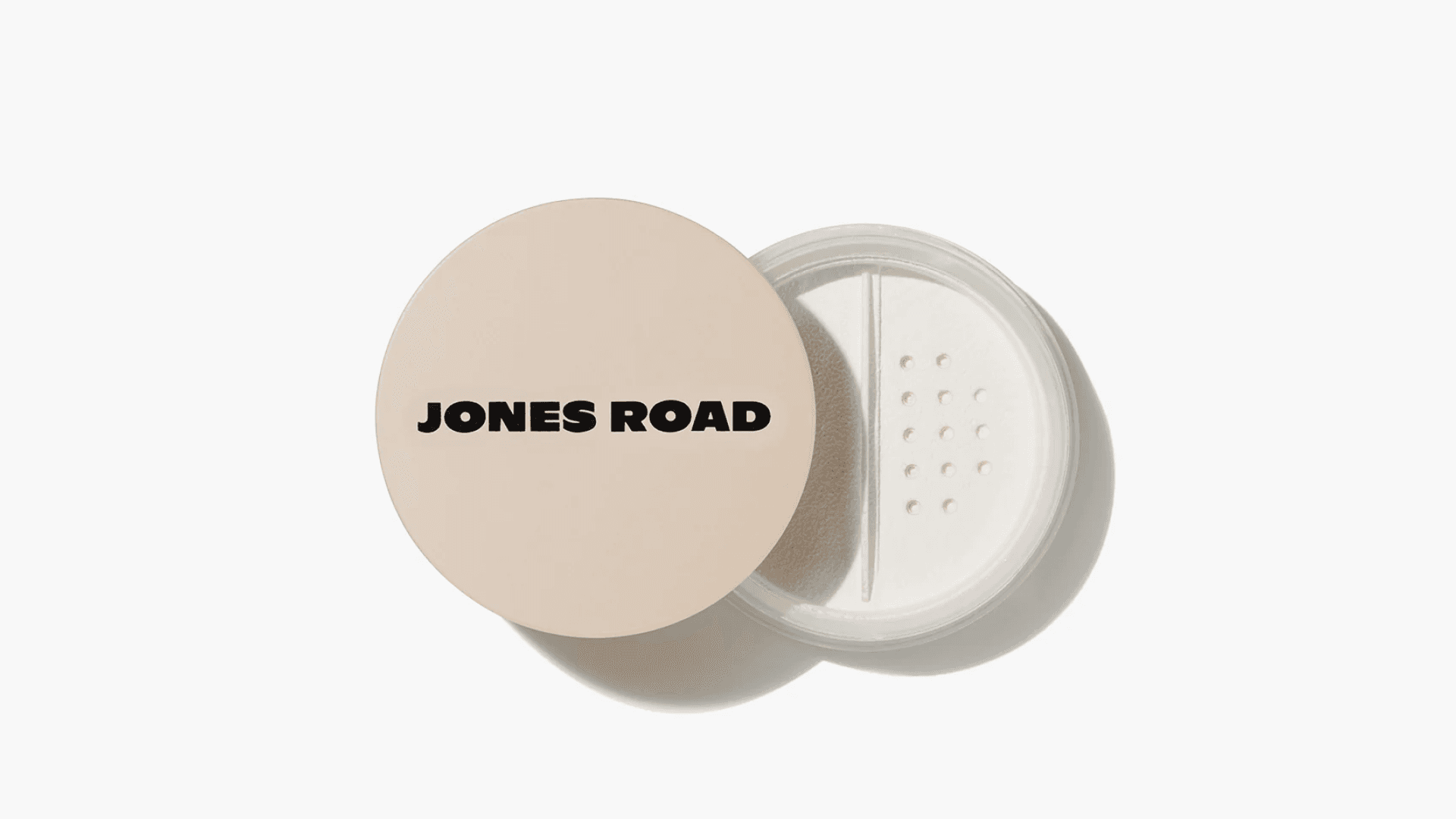 White face powder in container with "Jones Road" logo on lid