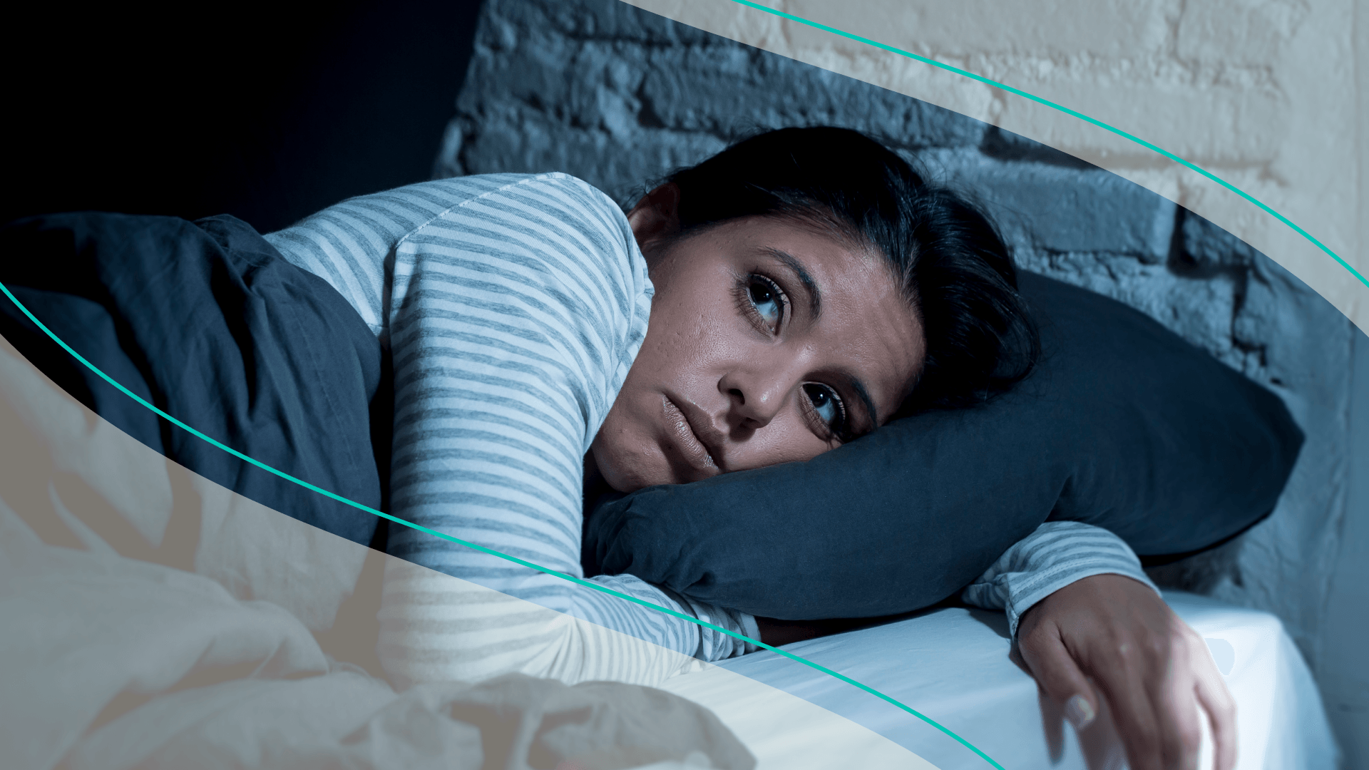 A woman lying in bed awake