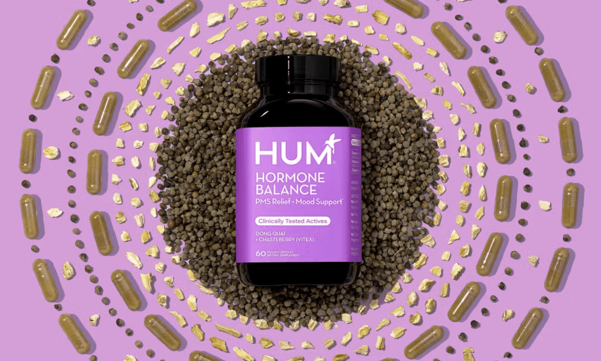 Brown glass bottle with purple layering surrounding by circles of supplements and herbs on purple background