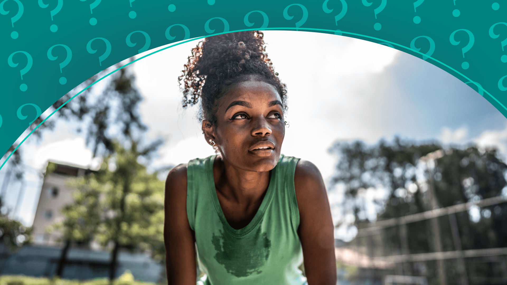 A woman with her hands on her knees in the sun