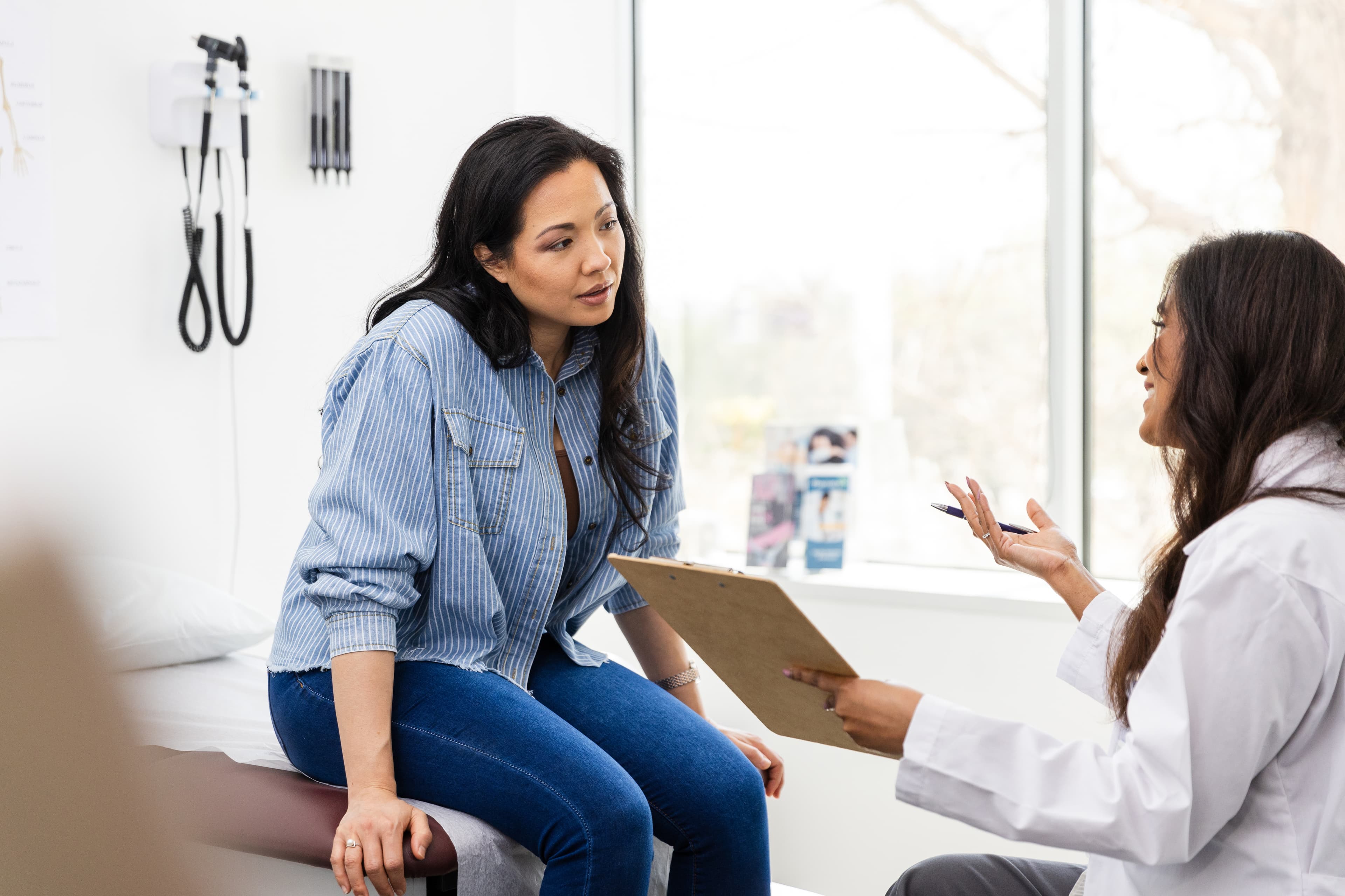 Woman talking to doctor at fertility clinic