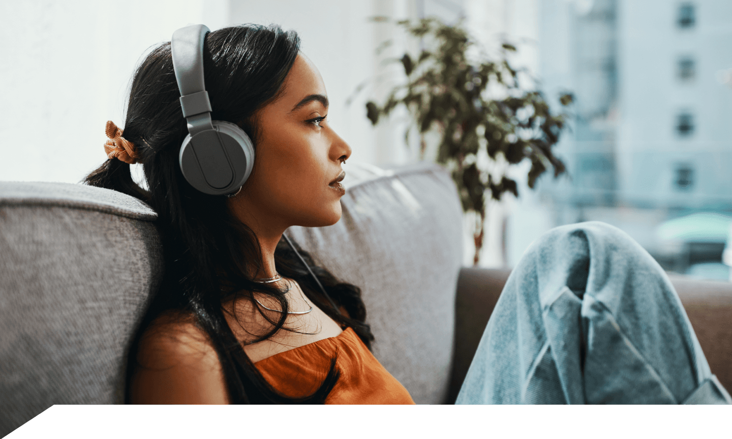 woman with headphones on couch