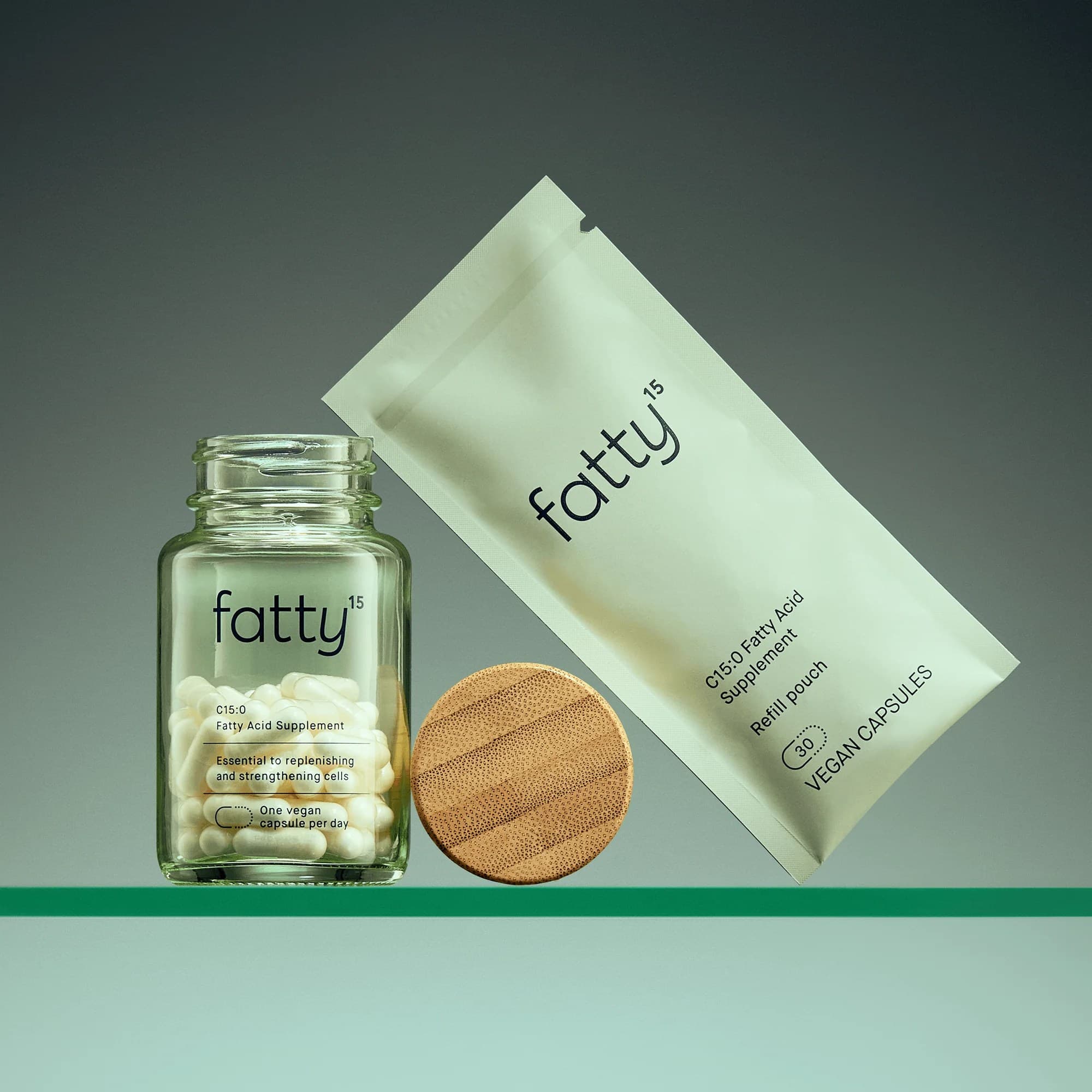 Green glass jar of supplements with packaging