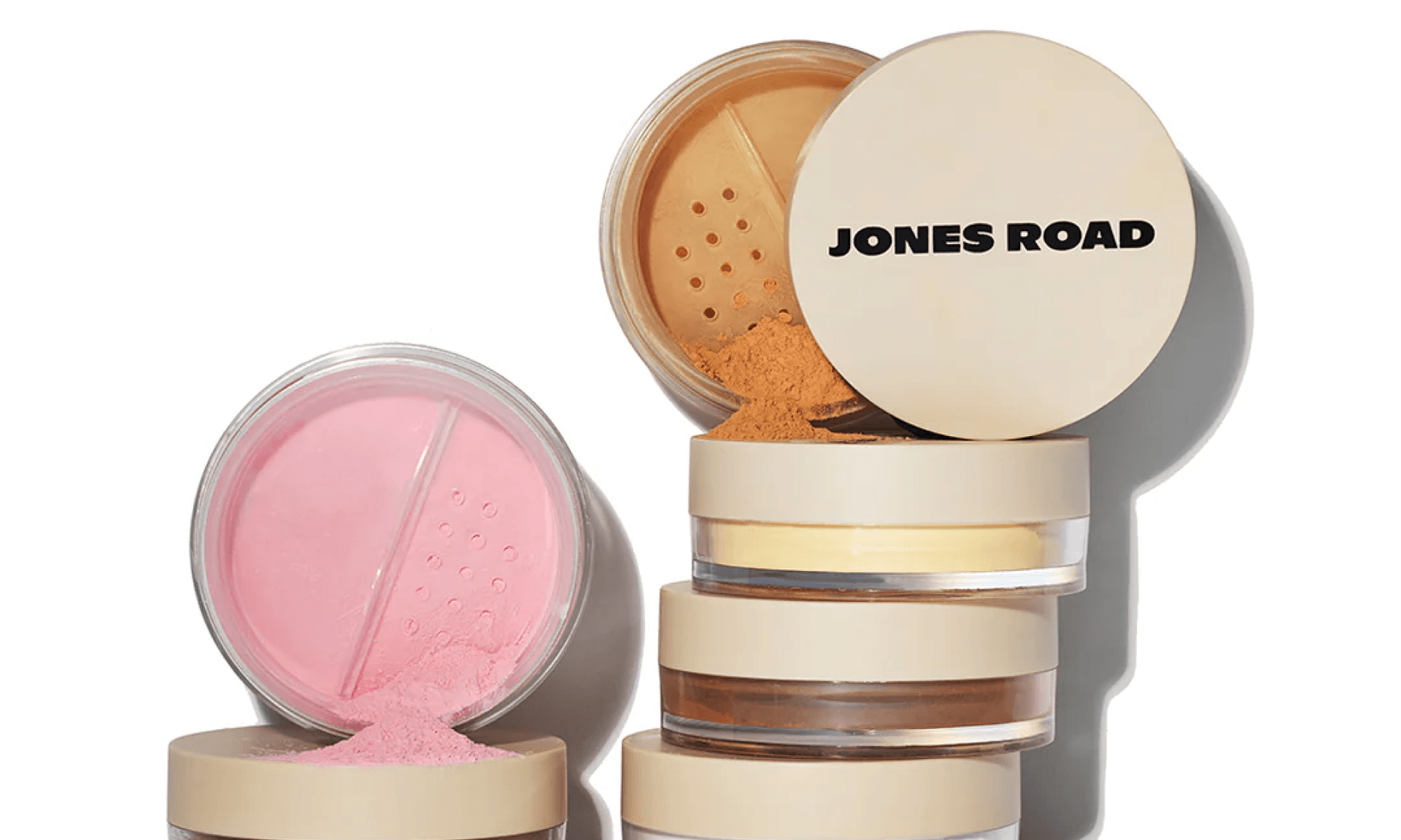 Two stacks of face powder containers in various shades