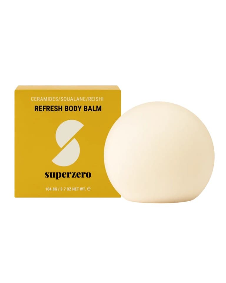 A white body-lotion bar next to its yellow box.