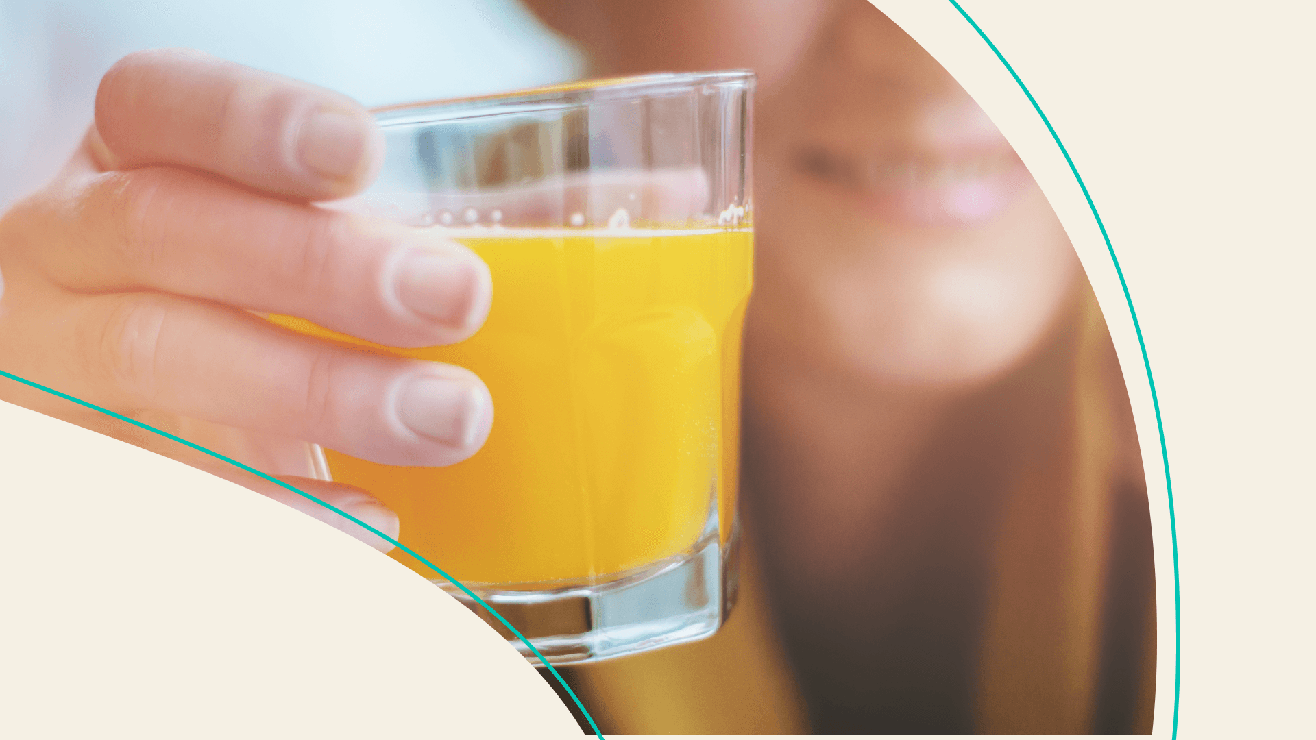 A woman holding a short glass of a juice