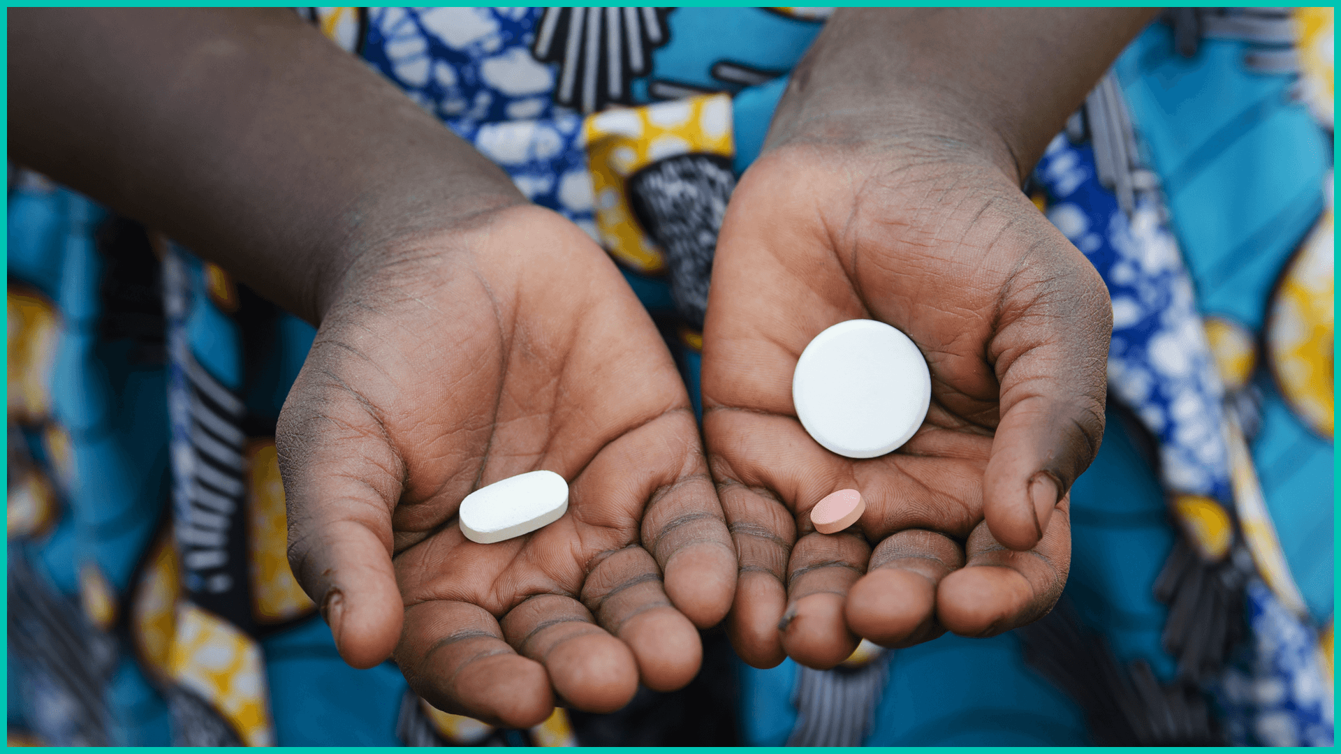 Small child holding pills