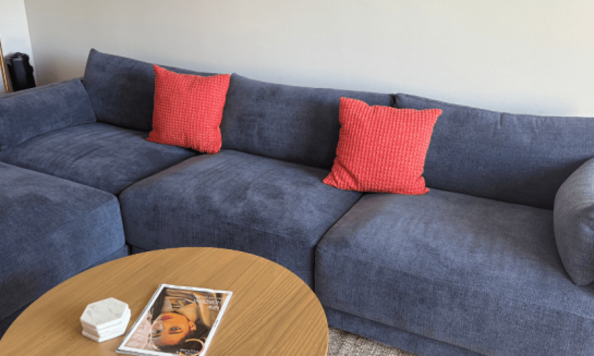 Blue sofa with red accent pillow